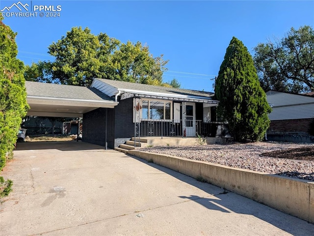 single story home featuring a carport