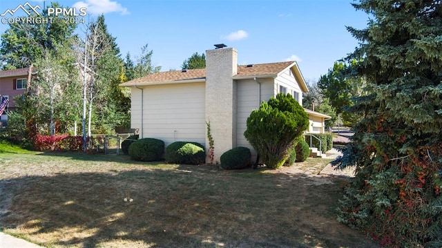 view of side of home featuring a yard