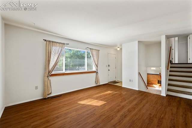 unfurnished room with hardwood / wood-style floors