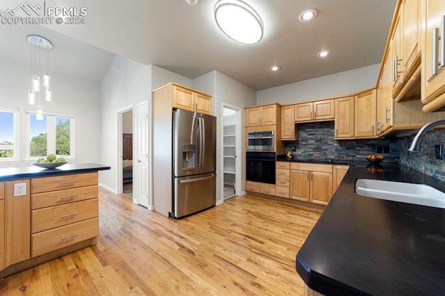 kitchen with light hardwood / wood-style floors, sink, hanging light fixtures, backsplash, and appliances with stainless steel finishes