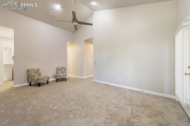 unfurnished room with ceiling fan, carpet flooring, and high vaulted ceiling