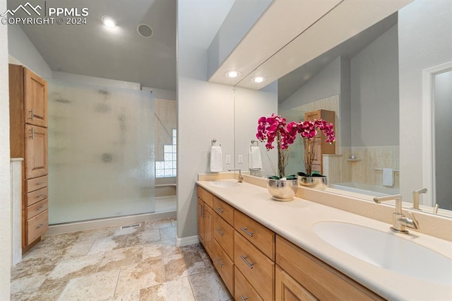 bathroom with vaulted ceiling, vanity, and separate shower and tub