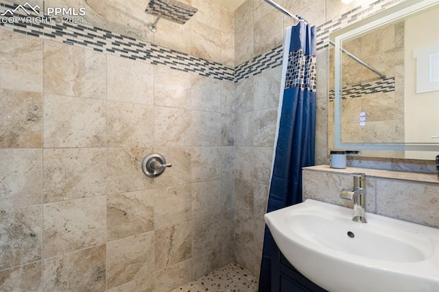 bathroom featuring vanity and curtained shower