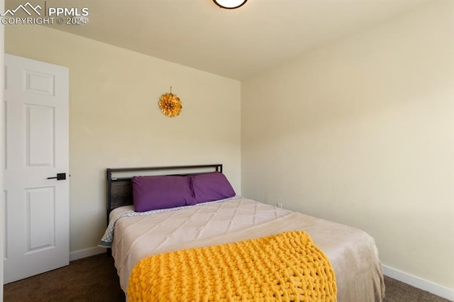 bedroom with dark colored carpet