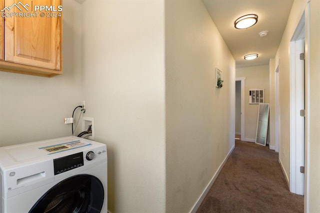 washroom with washer / dryer, cabinets, and dark colored carpet