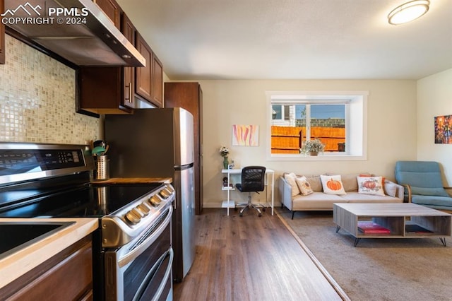309 S 2nd St, Cripple Creek, CO 80813 - kitchen featuring under cabinet range hood, stainless steel appliances, open floor plan, and dark wood-type flooring