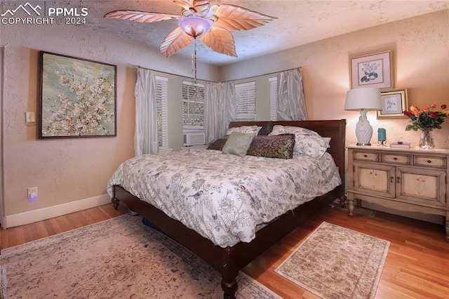 bedroom with light wood-type flooring and ceiling fan