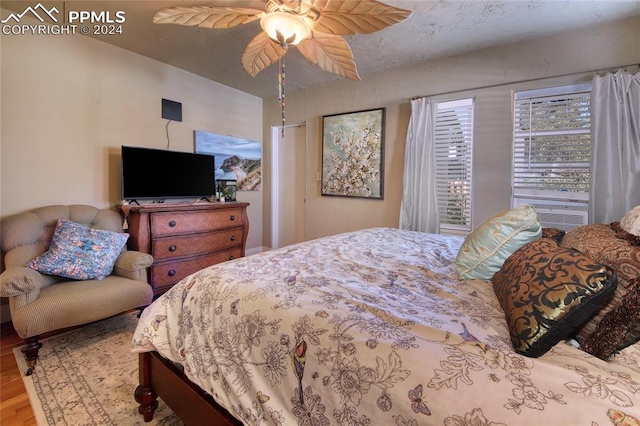 bedroom with hardwood / wood-style floors and ceiling fan