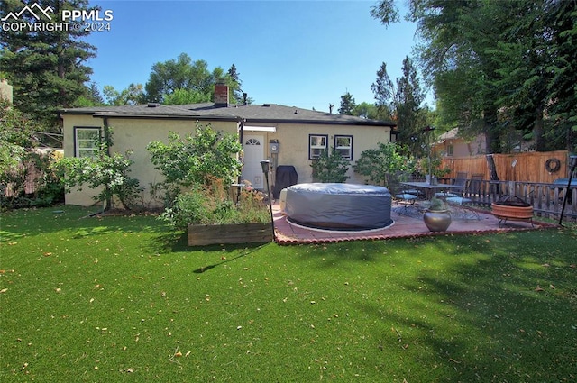 rear view of property featuring a patio and a yard