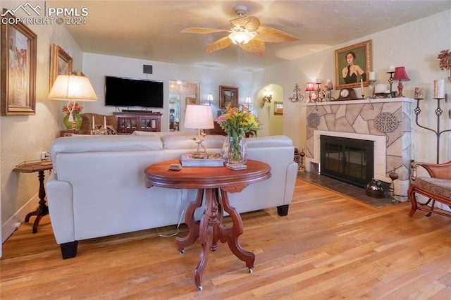 living room with ceiling fan and light hardwood / wood-style floors