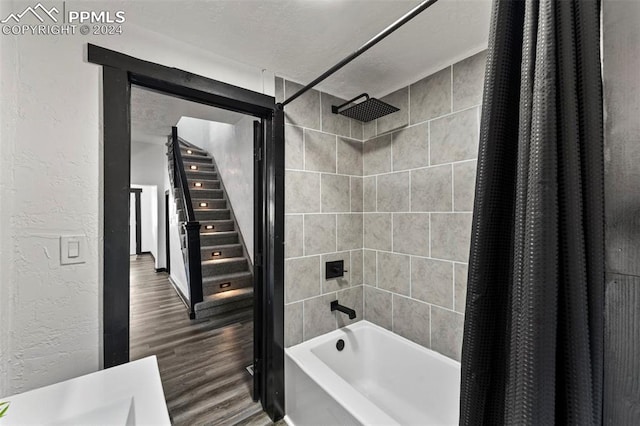 bathroom featuring shower / bathtub combination with curtain and hardwood / wood-style floors