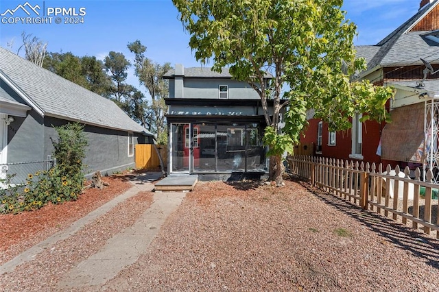 rear view of house featuring a sunroom