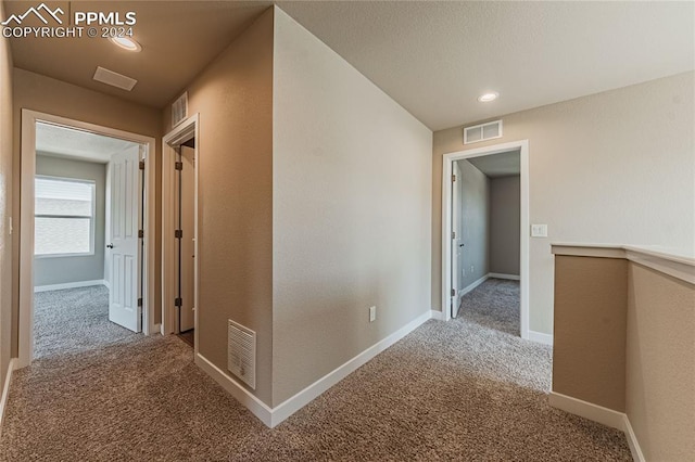 hallway featuring carpet