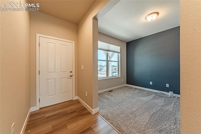 entryway with hardwood / wood-style floors