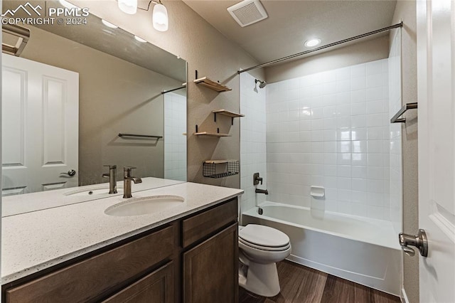 full bathroom with vanity, wood-type flooring,  shower combination, and toilet