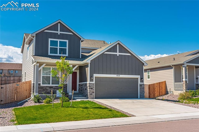 craftsman-style home with a garage and a front lawn