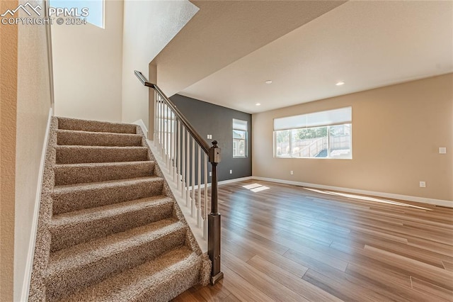 stairs with wood-type flooring