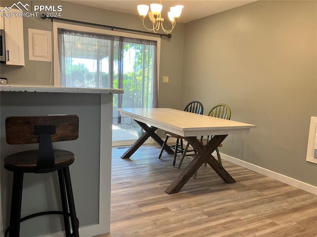 dining room featuring light hardwood / wood-style floors and an inviting chandelier