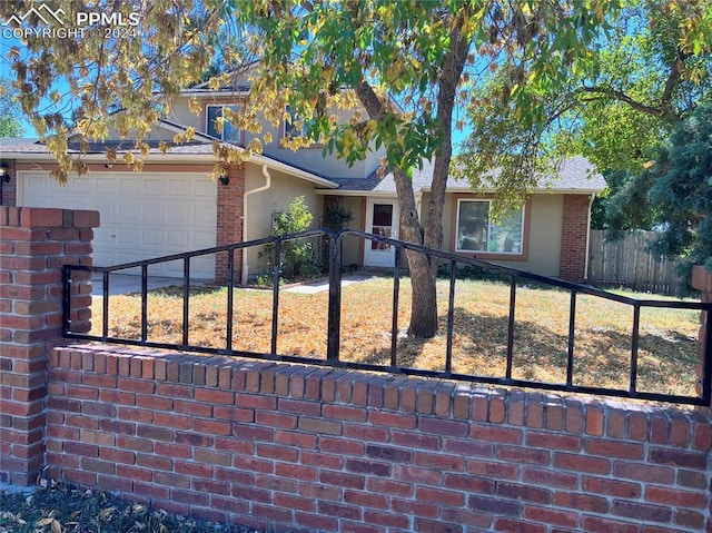 view of front of home with a garage and a front yard