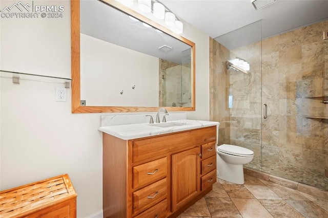 bathroom with a shower with shower door, vanity, and toilet