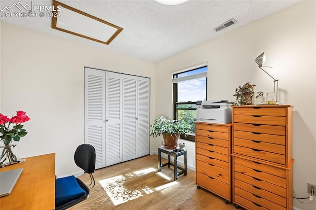 office space featuring a textured ceiling and hardwood / wood-style flooring