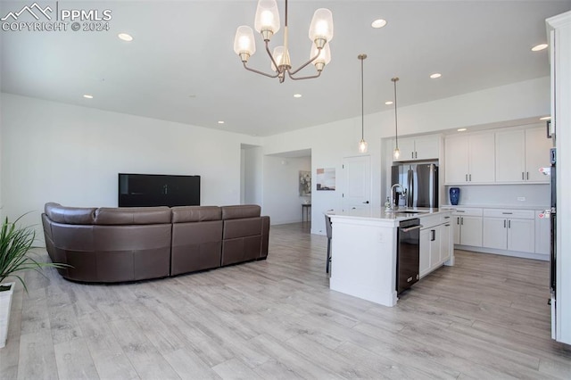 kitchen featuring pendant lighting, light wood-type flooring, a kitchen island with sink, stainless steel fridge with ice dispenser, and white cabinets