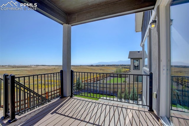 wooden deck with a rural view