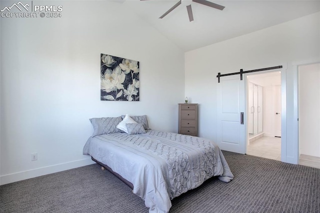 bedroom with a barn door, lofted ceiling, ceiling fan, and light colored carpet