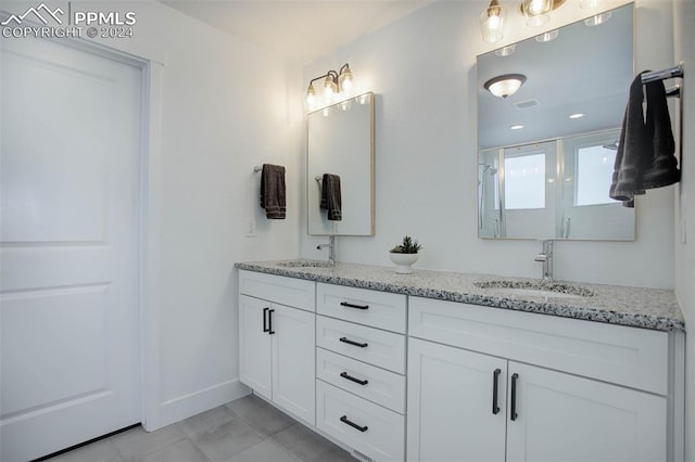 bathroom with walk in shower, tile patterned flooring, and vanity