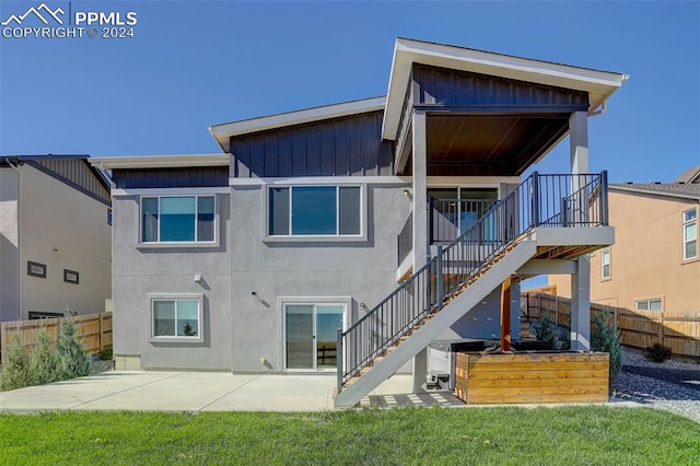 rear view of property with a patio and a yard