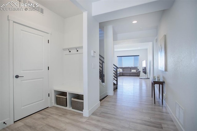 mudroom with light hardwood / wood-style flooring