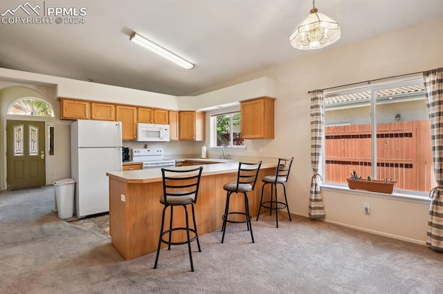 kitchen featuring light carpet, hanging light fixtures, kitchen peninsula, and white appliances