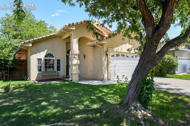 view of front of property with a garage and a front yard