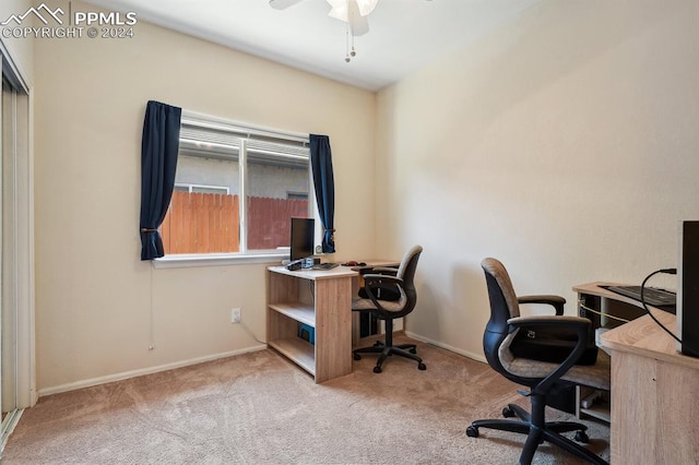 carpeted office space with ceiling fan