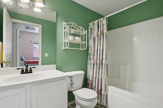 full bathroom featuring shower / bath combo, vanity, and toilet