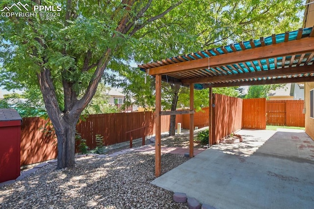 view of yard with a pergola and a patio area