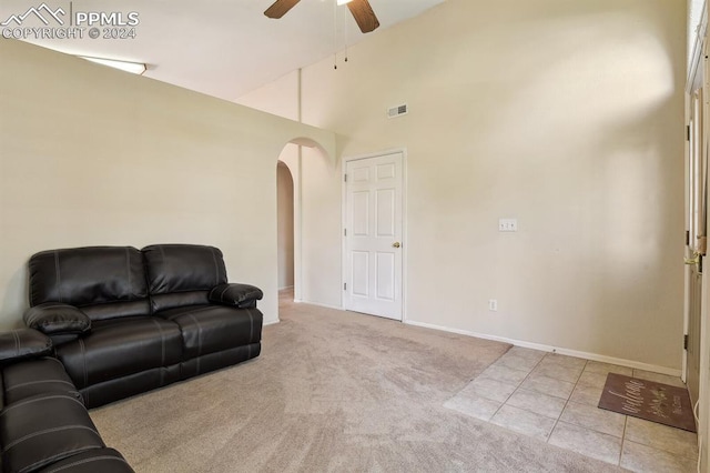 carpeted living room featuring ceiling fan and high vaulted ceiling