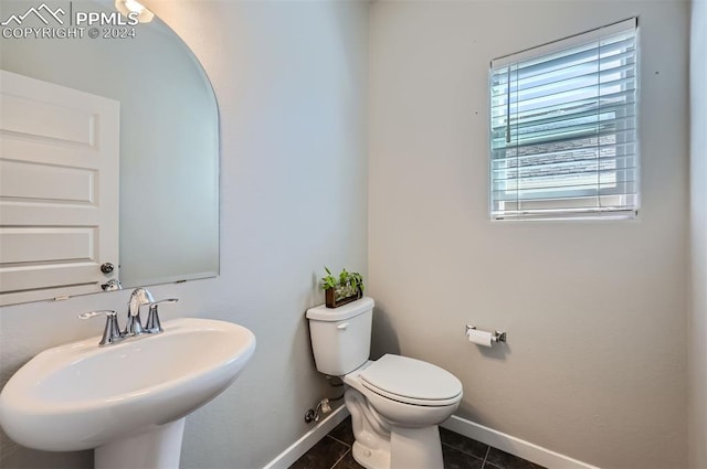 bathroom featuring sink, tile patterned floors, and toilet