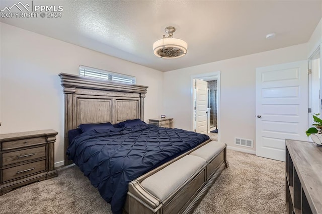 carpeted bedroom featuring a textured ceiling