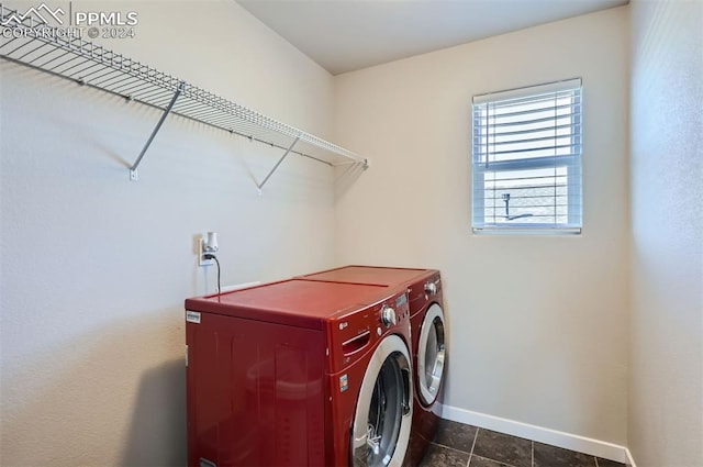 washroom with dark tile patterned flooring and separate washer and dryer