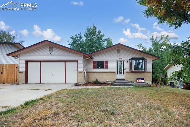 ranch-style home with a front yard and a garage