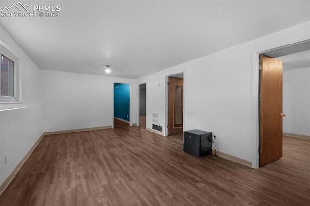 empty room with dark hardwood / wood-style flooring