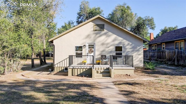 back of house with a wooden deck