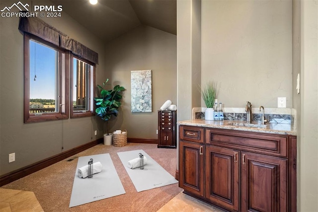 bathroom with sink and vaulted ceiling