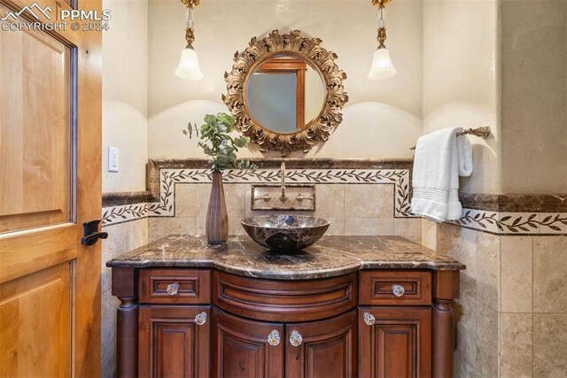 19155 Lochmere Ct, Monument, CO 80132 - bathroom with vanity and tile walls