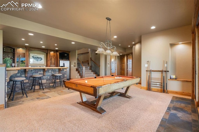 game room featuring pool table, light colored carpet, and bar area