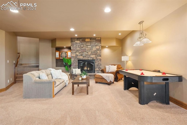 playroom featuring a stone fireplace and light colored carpet