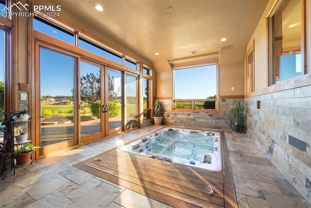 exterior space featuring a hot tub and french doors