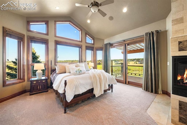 carpeted bedroom with ceiling fan, high vaulted ceiling, a tile fireplace, and access to exterior