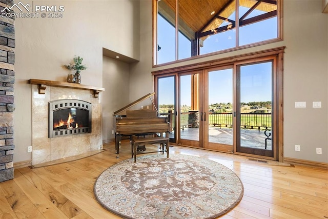 miscellaneous room featuring french doors, light hardwood / wood-style floors, high vaulted ceiling, and wooden ceiling